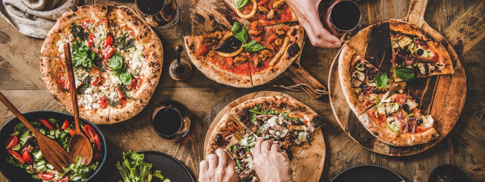 family-having-pizza-dinner-party-with-red-wine-top-view-e1608058941288